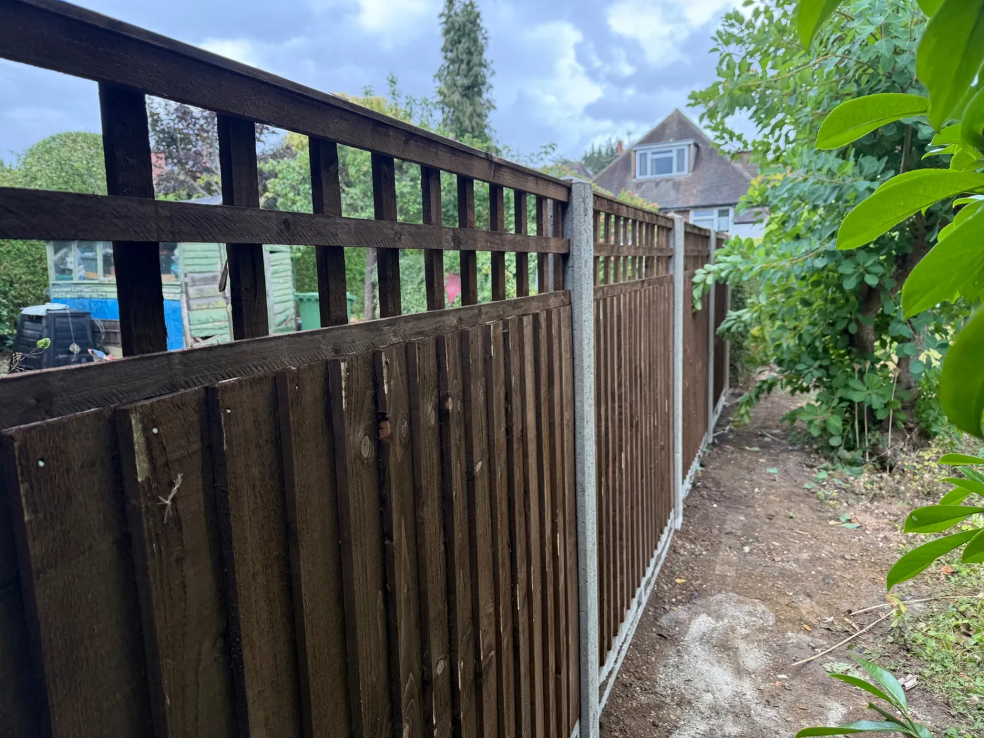 Closeboard fencing along a garden boundary
