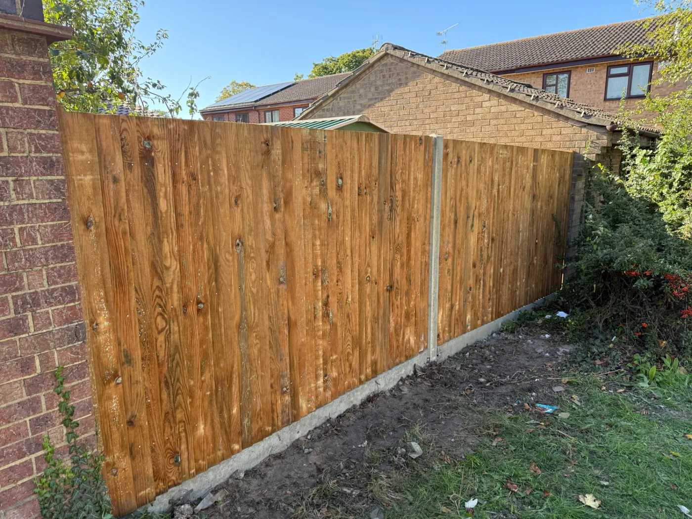 Fence line fitted along a wooded garden boundary