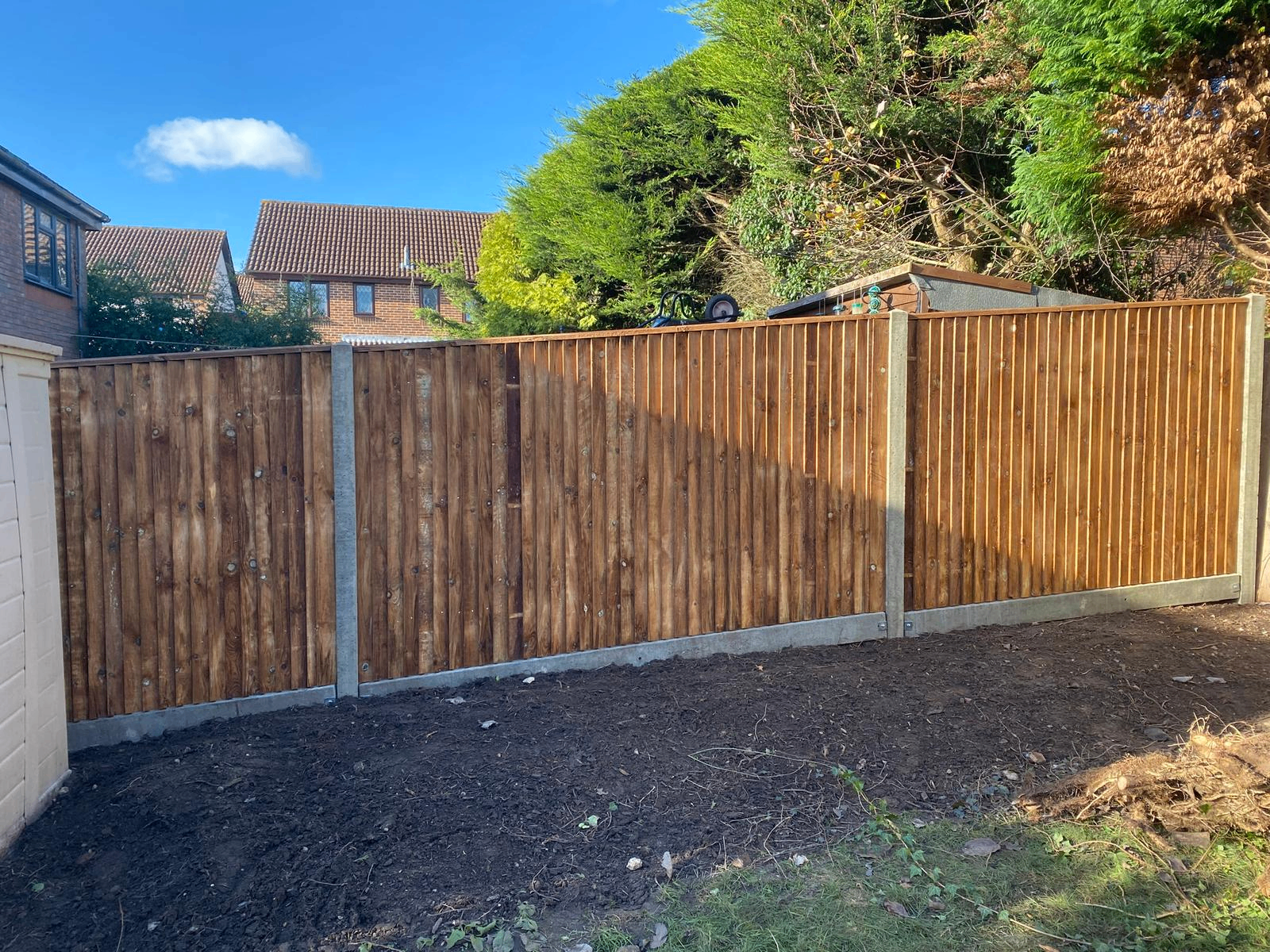 Wide run of timber fencing in a rear garden